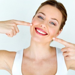 Woman pointing at smile after dental bonding treatment