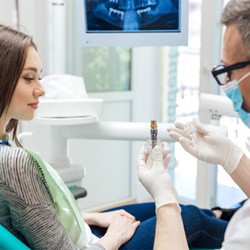 A dentist explaining the benefits of dental implants 