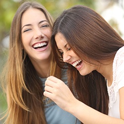 Two ladies with tooth colored fillings laughing together