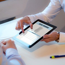 A dental patient filling out a dental insurance form