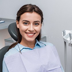 Woman with beautiful smile sitting in treatment chair