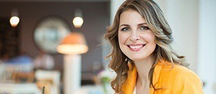 lady in yellow blouse smiling