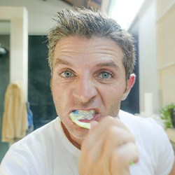 Man brushes teeth