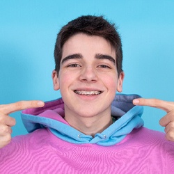 teen pointing to the braces in their mouth