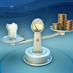 Tooth and coins on a balance scale