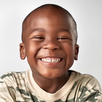 Child smiling brightly on white background
