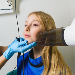 Young girl getting X-ray taken