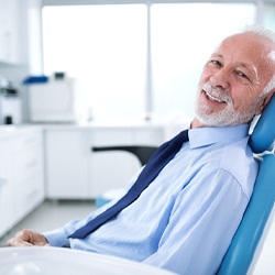 Older man smiling in dental chair