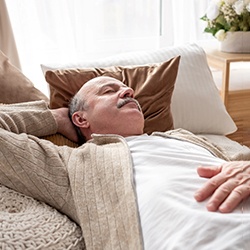 Man resting after getting dental implants in McKinney