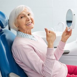 Senior dental patient giving thumbs up gesture