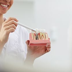 Dentist showing a patient how dental implants in McKinney work