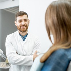 Dentist smiling at patient during consultation  