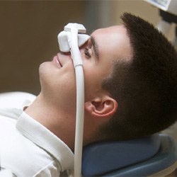 Male patient relaxing while breathing in nitrous oxide  