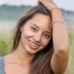 Girl with clear and ceramic braces posing for a picture