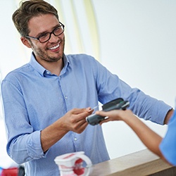 A man paying for orthodontic treatment