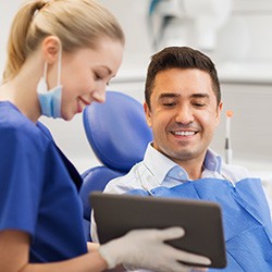 A dentist explaining gum disease treatment aftercare to a patient
