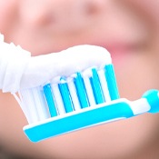 Closeup of putting toothpaste on toothbrush