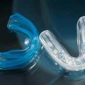 Pair of athletic mouthguards on a see-through table