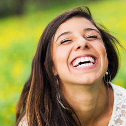 Young woman laughing after receiving porcelain veneers