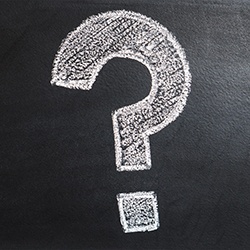 Question mark on blackboard representing frequently asked questions about porcelain veneers