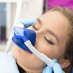 Young lady with nitrous oxide dental sedation mask relaxed during dental visit