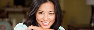 Smiling woman with healthy teeth and gums after periodontal therapy