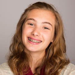 Girl with braces smiling during orthodontics visit