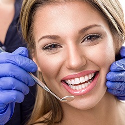 Woman receiving dental checkup and teeth cleaning