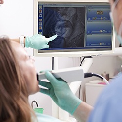 Dentist pointing at image from intraoral camera