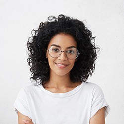 Woman smiling after getting porcelain veneers in McKinney