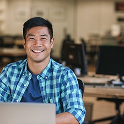 Man smiling after finding out how to afford the cost of porcelain veneers in McKinney