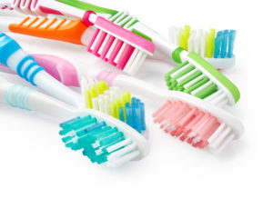 A variety of different colored toothbrushes