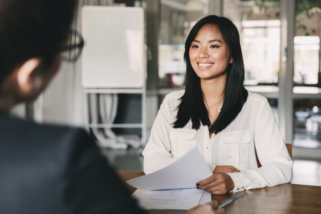 person smiling at job interview after teeth whitening