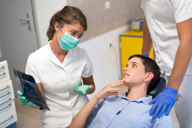 Patient talking to dentist about tooth extraction