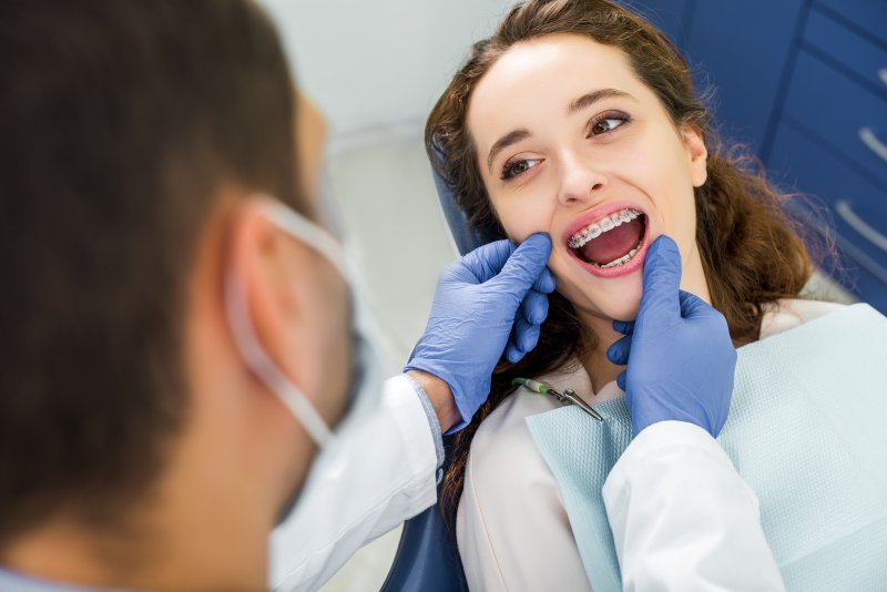 Patient smiling at orthodontist after orthodontic emergencies